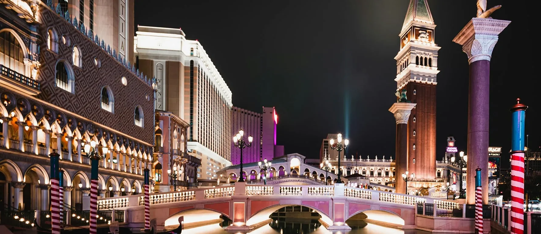 as Vegas Venetian Resort with canal, bridge, and tower at night