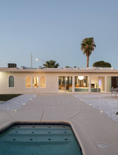 Arapaho property backyard with pool, lounge chairs, and modern exterior