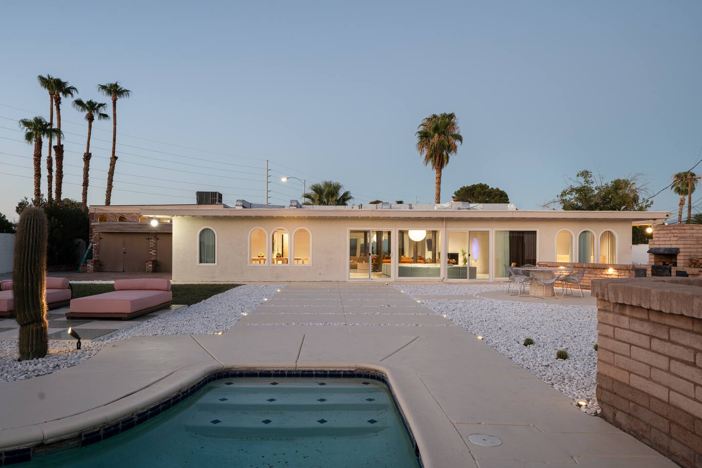 Arapaho property backyard with pool, lounge chairs, and modern exterior