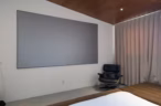Arapaho property bedroom with large projector screen and lounge chair