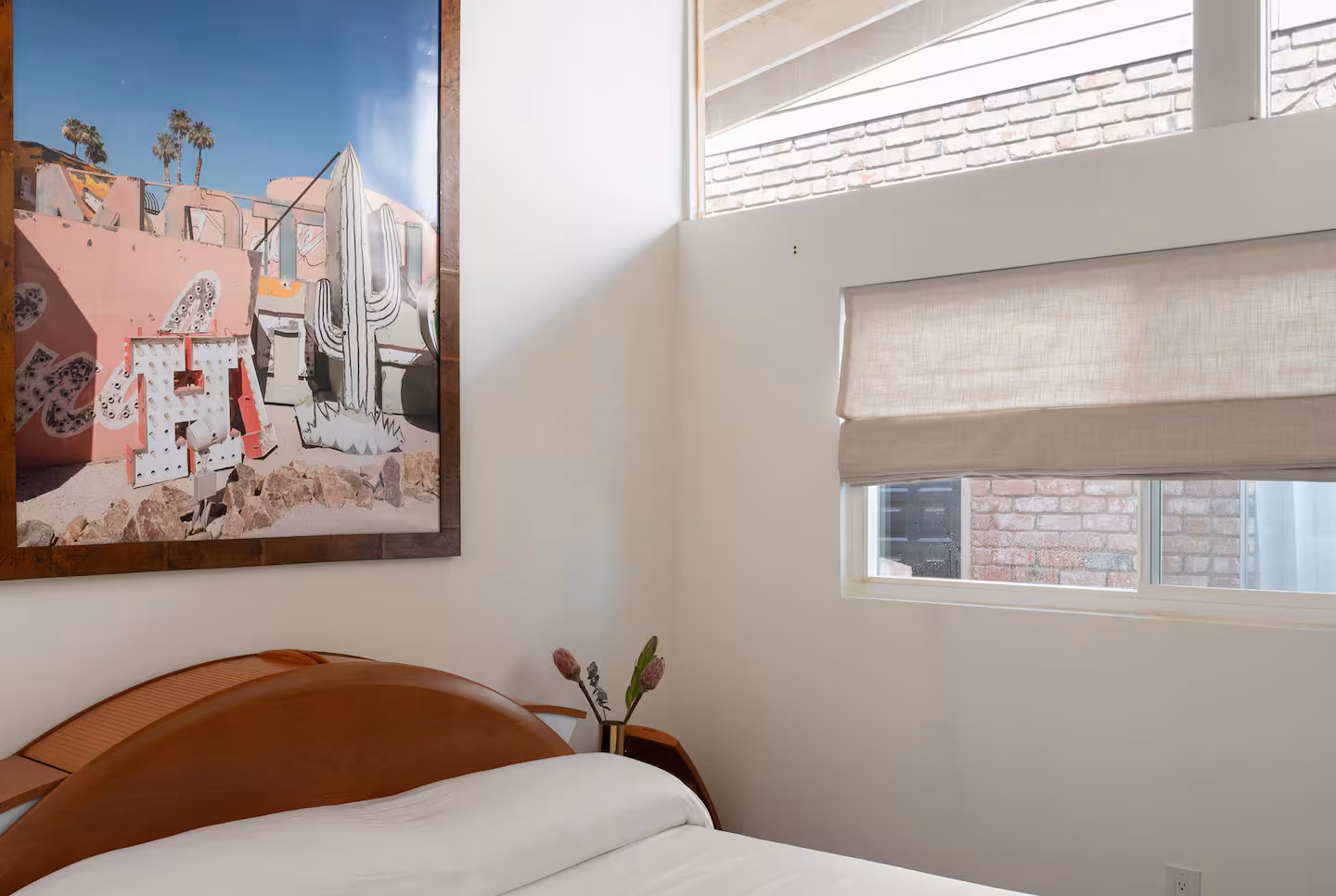 Arapaho property bedroom with wooden bed and framed wall art