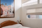 Arapaho property bedroom with wooden bed and framed wall art