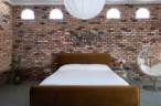 Arapaho property bedroom with brick accent wall and modern decor