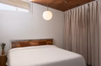 Arapaho property cozy bedroom with wooden headboard and pendant light
