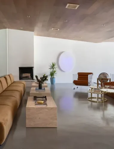 Arapaho property modern living room with brown sofas, fireplace, and decor