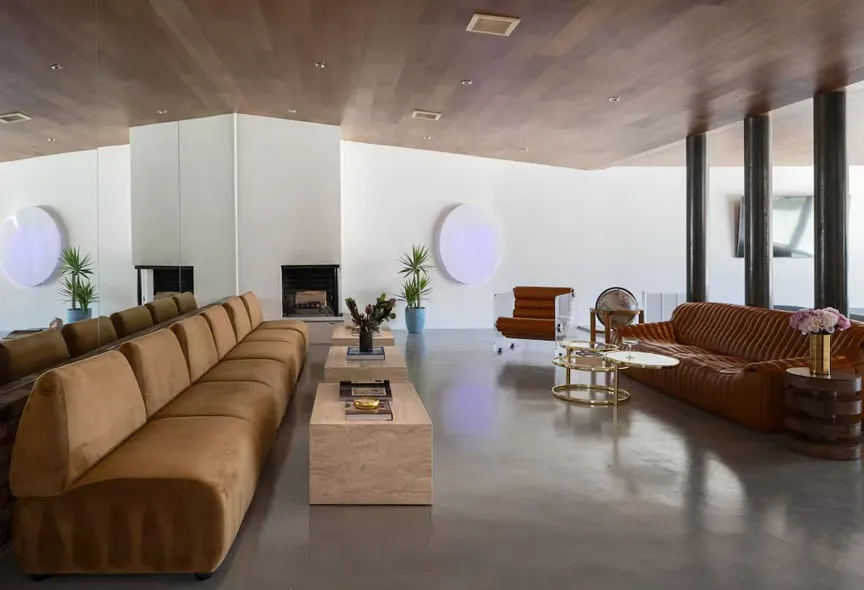 Arapaho property modern living room with brown sofas, fireplace, and decor