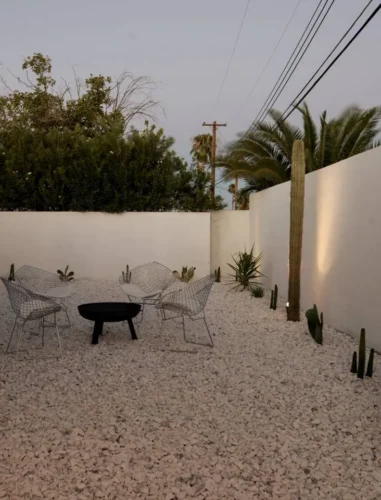 Arapaho property outdoor firepit area with chairs and desert landscaping